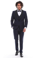 Navy tuxedo with satin details and a shawl lapel, including a white shirt and bow tie.